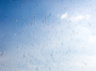 Soap bubbles fly in the blue sky