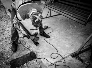 A worker cuts metal at a construction site
