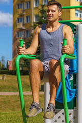 Man doing sit ups in outdoor gym