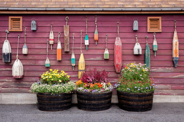 Wooden buoys hanging on wall at the marine port