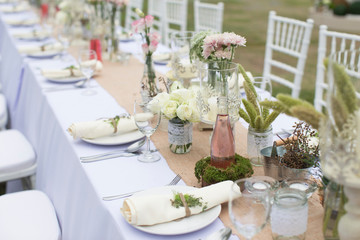Outdoor catering dinner at the wedding with homemade garnishes decoration