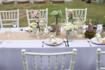 Outdoor catering dinner at the wedding with homemade garnishes decoration