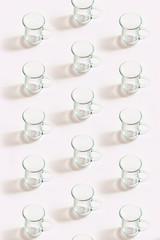 Transparent glass cups put in pattern. Flat lay view from top