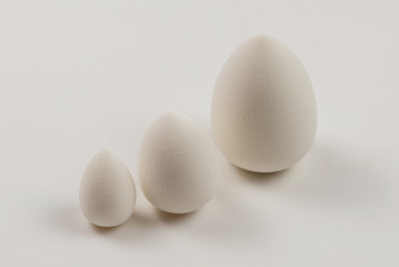 Small, medium and large  white beauty blender isolated.