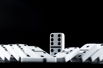 Domino pieces put in a row on black background