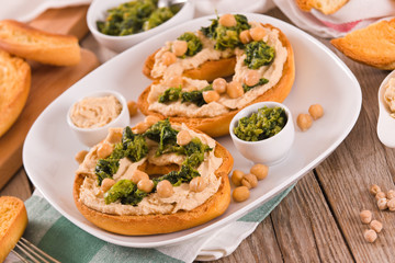 Friselle with turnip tops and hummus.