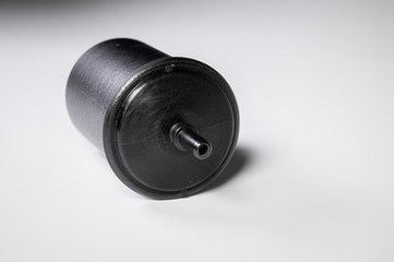 Obraz na płótnie Canvas New fuel filter in a black plastic housing for diesel and gasoline engines on a gray background
