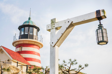 Fototapeta premium Lamps on street at harbor hanging from wooden poles in sunny day