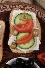 Sandwich with cream cheese, tomato and cucumber.