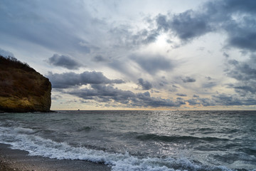 Waves rolled on the rocky shore of the sea.