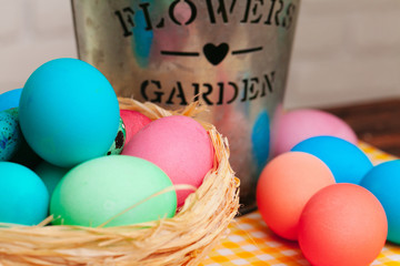 Easter decorative nest with colored eggs close up