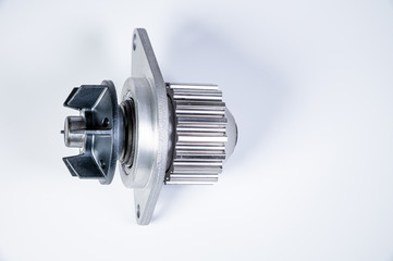 New metal automobile pump for cooling the engine of a water pump on a gray background. The concept of new spare parts for the car engine