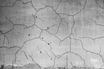 Texture of a concrete wall with cracks and scratches which can be used as a background