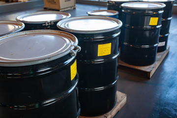 Group of steel drums storing hazardous waste in a sheltered accumulation area