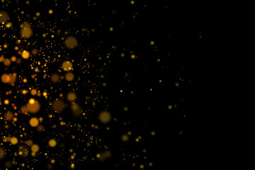 Fototapeta na wymiar Gold glittering light bokeh abstract particles in dark background.