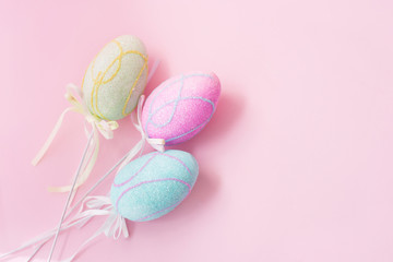 Easter eggs on pink background with copyspace