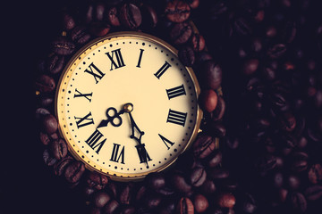 Antique clock with Roman numerals and coffee beans