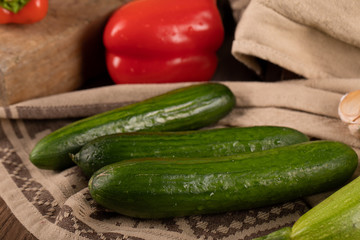 Green cucumbers on a rustic towel