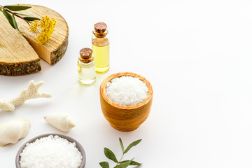Spa salon concept. Salt, oil and soap on white background copy space