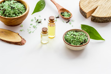 Spa salon concept. Salt, oil and soap on white background