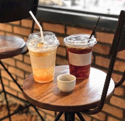Ice coffee in a tall glass, ready to drink Cool summer drinks on the table are wooden floors.