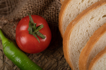 A tomato and sliced white bread.