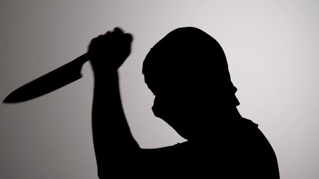 Criminal Stabbing with Knife, Serial Killer Horror Concept, Silhouette