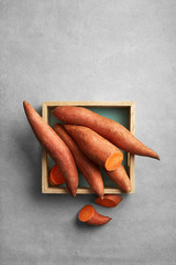 Sweet potato in a rustic box viewed from above. Batata or yam. Top view