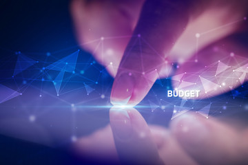 Finger touching tablet with BUDGET inscription, business concept