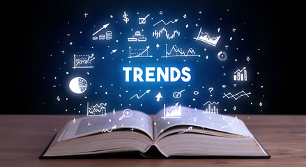 TRENDS inscription coming out from an open book, business concept