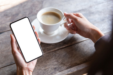 Mockup image blank white screen cell phone.man hand holding texting using mobile on desk at coffee shop.background empty space for advertise text.people contact marketing business,technology