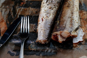 baked fish hake in the oven with herbs