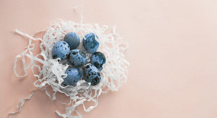 Blue quail eggs on pink background. Easter concept