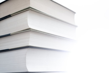 Thick paper books are a symbol of education and wisdom. A stack of books on the table. Storage and dissemination of information.