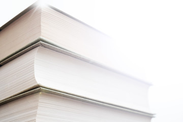 Thick paper books are a symbol of education and wisdom. A stack of books on the table. Storage and...