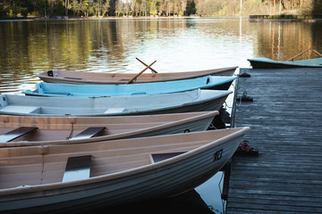 Multi-colored boats on a pier on Lake Tikhoe, Svetlogorsk, Russia.