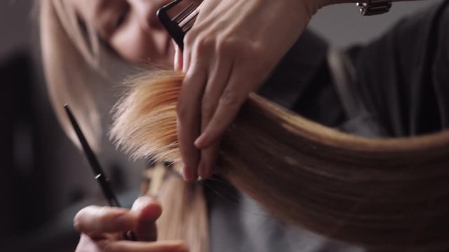 Hair salon girl haircuts. Close up 4K slow motion
