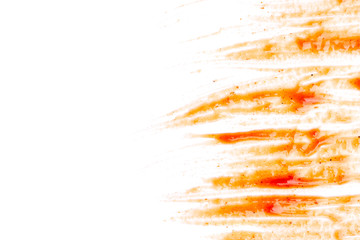 Smeared barbecue sauce or ketchup isolated on white background, close up, macro. Flat lay, top view. Free copy space.