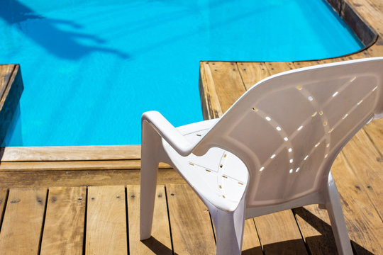 Pool Side Chair Plastic White Rustic Furniture Object Outside Exterior Space Advertising Wallpaper Background Concept Sunny Bright Lighting