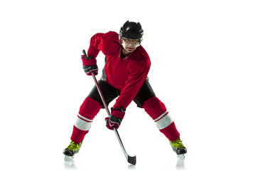 Fototapeta na wymiar Leader. Male hockey player with the stick on ice court and white background. Sportsman wearing equipment and helmet practicing. Concept of sport, healthy lifestyle, motion, movement, action.