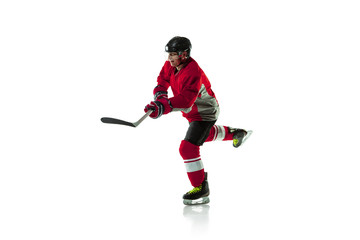 Obraz premium Leader. Male hockey player with the stick on ice court and white background. Sportsman wearing equipment and helmet practicing. Concept of sport, healthy lifestyle, motion, movement, action.