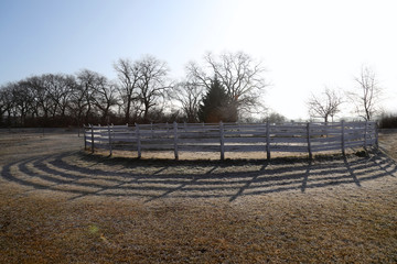 Round pen for horse exercise and training on frosty morning wintertime