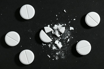 White pills on black background macro photo - concept of medicine and medication treatment, health...