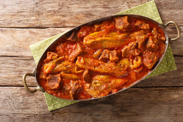 khoresh bademjan, Persian eggplant, meat and tomato stew braised with spices close-up in a pan. Horizontal top view