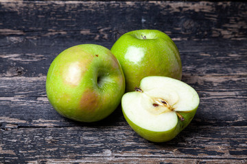 green apples on an old wooden background