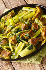 Celery stew Khoresh Karafs is healthy and delicious Iranian dish. It's a combination of meat, evenly sliced celery  and herbs closeup in the plate. vertical
