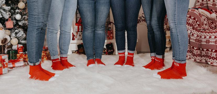Close up photo of kids/people feet  wearing colorful red socks