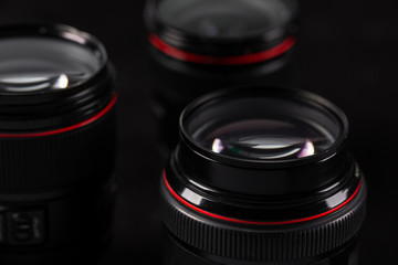 Fototapeta na wymiar photo lenses close-up on a black blurred background