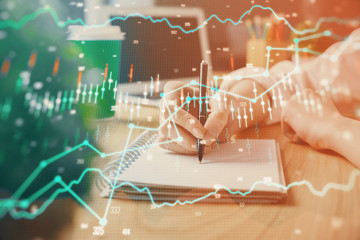Forex chart displayed on woman's hand taking notes background. Concept of research. Double exposure