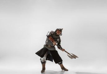 Brave armored knight with professional weapon fighting isolated on white studio background. Historical reconstruction of native fight of warriors. Concept of history, hobby, antique military art.